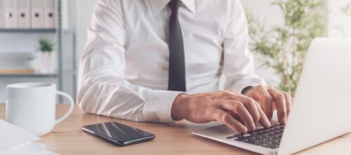 employee working on laptop for hybrid cloud solutions