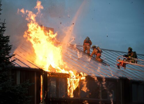 Building on fire with fire fighters