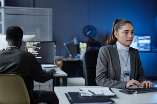 coworkers working on computers in office