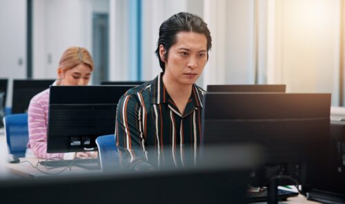 coworkers in office using computer solutions from an MSP