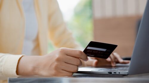 woman entering card information through online store adhering to pci compliance requirements