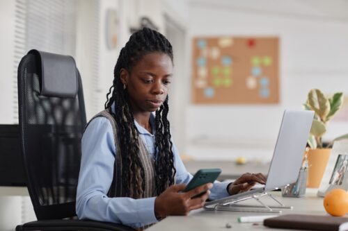 woman working on computer in office with the help of outsourced it services